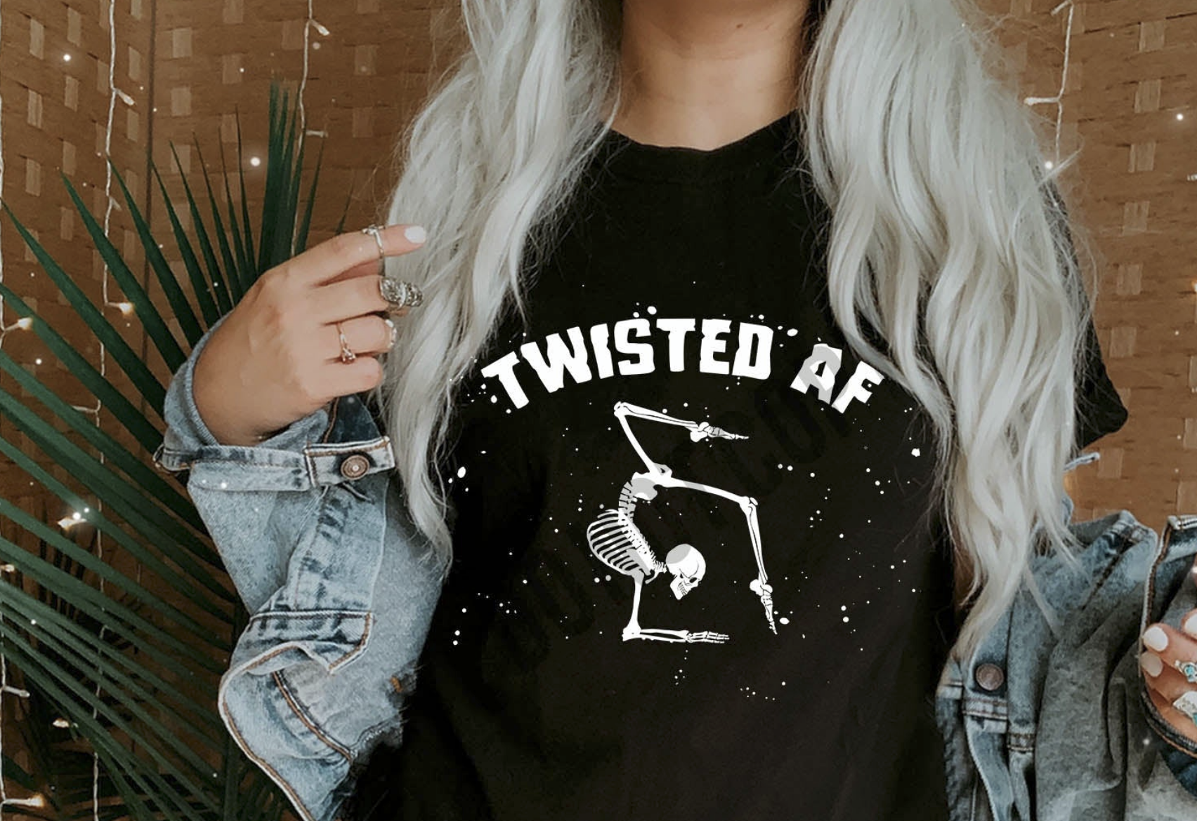 Black t-shirt with white skeleton graphic in twisted pose and text “Twisted AF” – funny Halloween shirt
