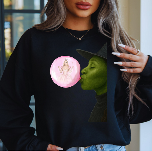 Black sweatshirt featuring green witch blowing pink bubble with fairy inside.

Fantasy art crewneck with witch and fairy bubble design.

Cozy black sweatshirt with magical bubble illustration.

Woman wearing fantasy witch and fairy graphic sweatshirt.