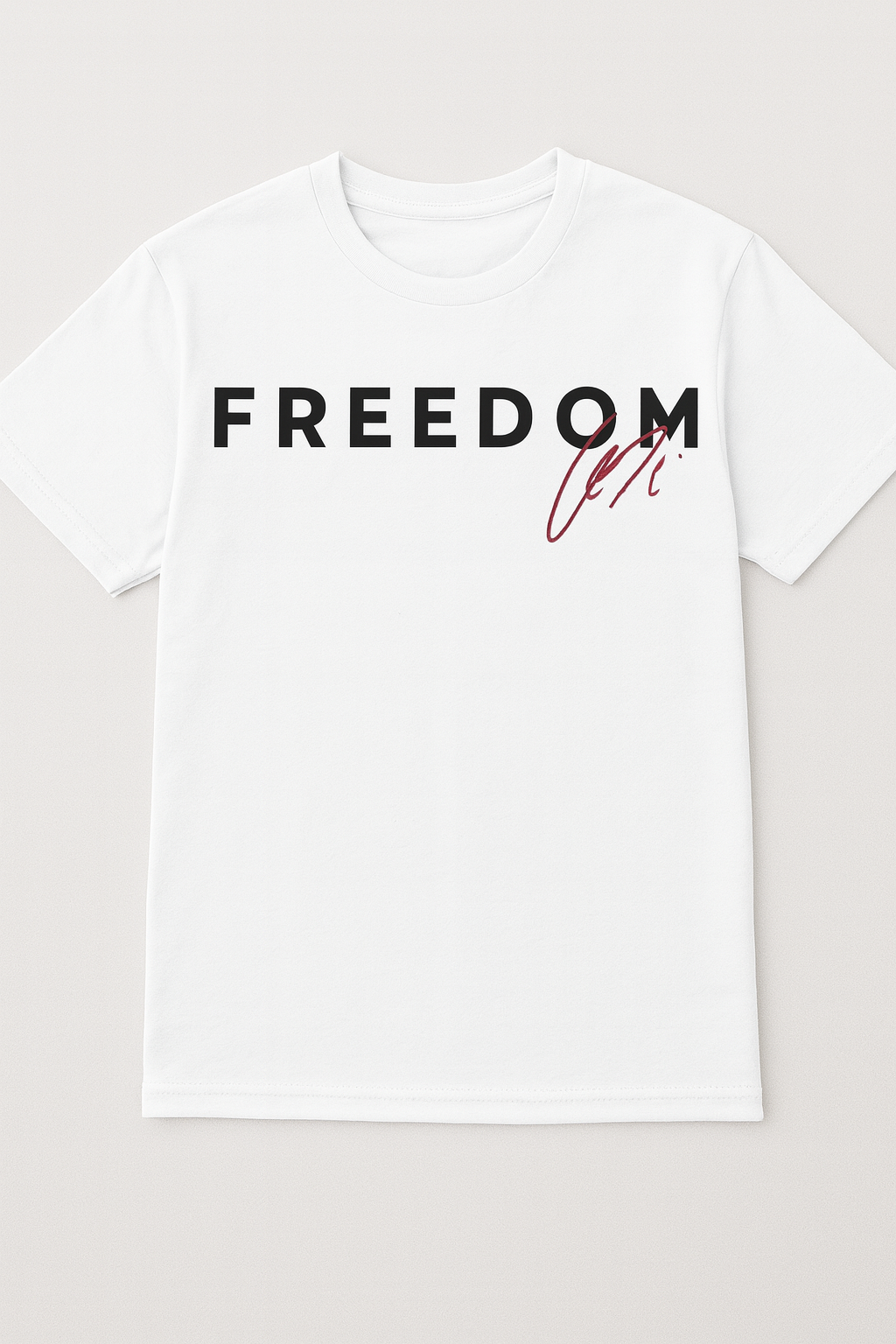 White T-shirt with bold black FREEDOM text and red signature accent centered on chest