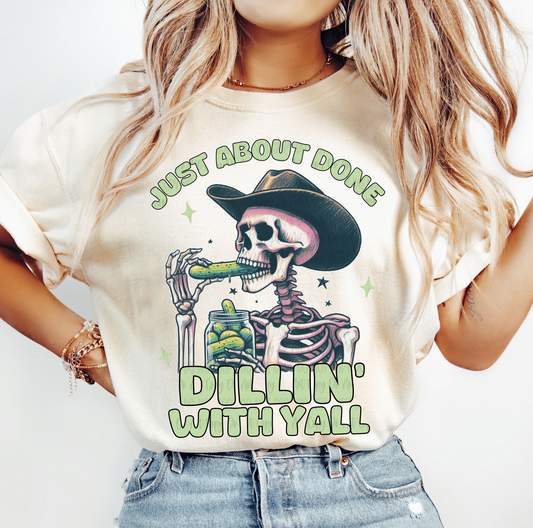 Just About Done Dillin With Y'all skeleton cowboy graphic tee with pickle jar on beige shirt
