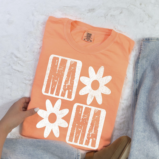 Peach graphic tee with block “MAMA” text and white daisy flowers – $15 mom life t-shirt