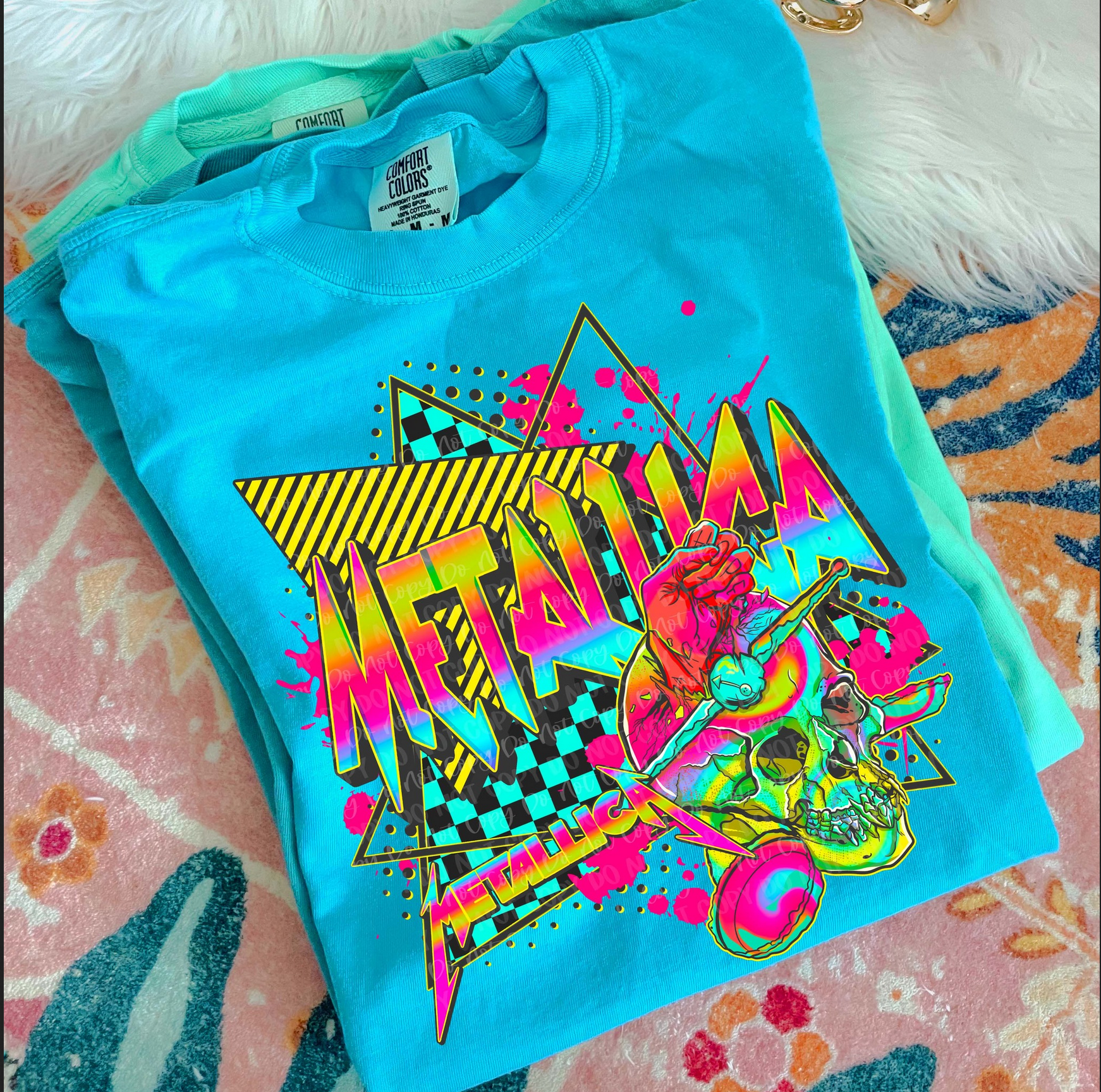 Metallica neon retro graphic tee in blue with skull and bold logo design