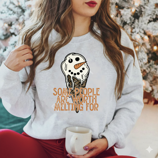 Woman wearing gray sweatshirt with cute melting snowman and quote “Some people are worth melting for.”

Close-up of melting snowman graphic on cozy winter crewneck.

Cute winter sweatshirt styled for holiday and cold-weather outfits.

Soft unisex crewneck with inspirational snowman design.