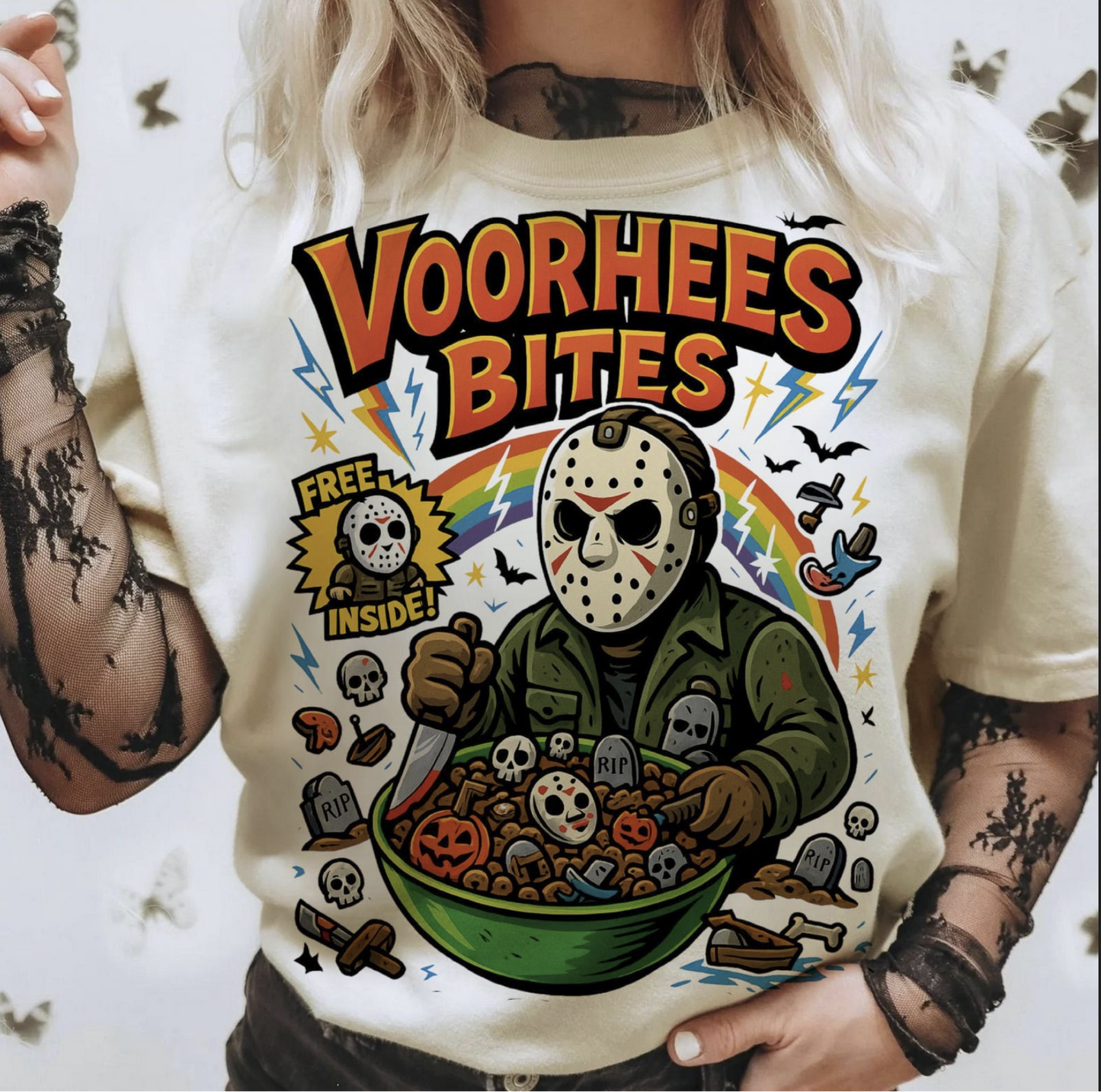 Beige t-shirt with cartoon Jason Voorhees eating spooky cereal, text ‘Voorhees Bites’ – retro funny horror graphic tee